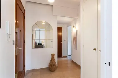 a hallway with a vase sitting on a tile floor at ARM1 - Beau 2 pièces avec terrasse d'angle in Cannes