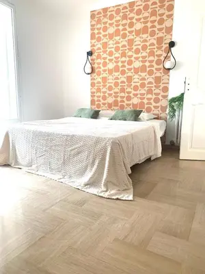 a white bed in a room with a window at La Maison by Simone, la vrai in Cannes