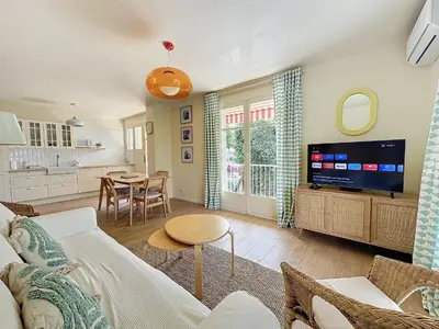a living room with a couch and a tv at 63m2 Grande Terrasse, Clim in Cannes