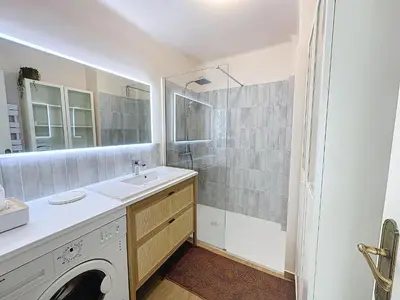 a bathroom with a sink and a washing machine at 63m2 Grande Terrasse, Clim in Cannes