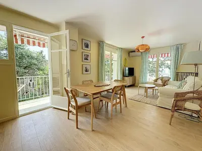 a living room with a table and chairs and a couch at 63m2 Grande Terrasse, Clim in Cannes