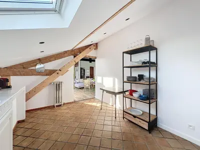 a living room with a staircase and a vaulted ceiling at 140m2 vue mer, 3 chambres, centre-ville in Cannes