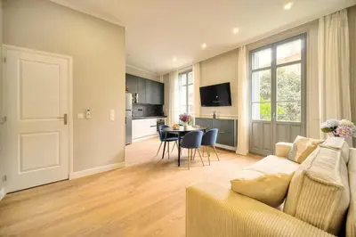 a living room with a couch and a table at Marigold - 2 Bed 2 bath - AC - 8 min from Palais in Cannes