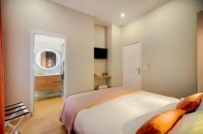 a bedroom with a large bed and a window at Marigold - 2 Bed 2 bath - AC - 8 min from Palais in Cannes
