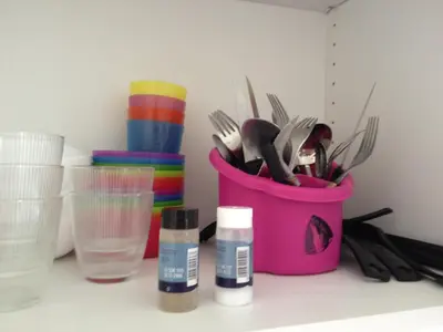 a pink bucket filled with utensils on top of a counter at Cannes plage 2 pièces Croisette centre ville in Cannes