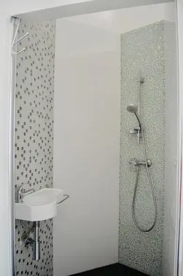 a bathroom with a shower and a sink at Cannes plage 2 pièces Croisette centre ville in Cannes