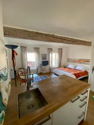 a kitchen with a sink and a bed in a room at Appartamento coeur du Suquet in Cannes