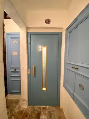 a blue door in a hallway with at Appartamento coeur du Suquet in Cannes