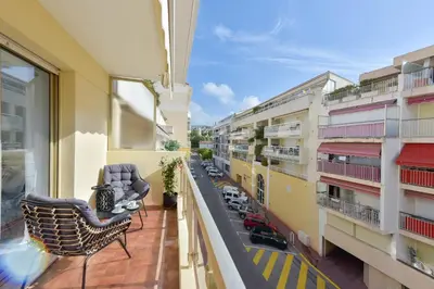 an apartment balcony with chairs and a view of a street at Apartment with Terrace walk to Beaches & Shopping in Cannes