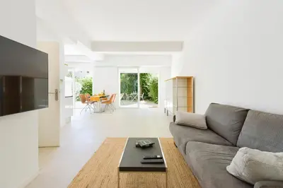 a living room with a couch and a table at 1-bedroom apartment walk to beach garage in Cannes