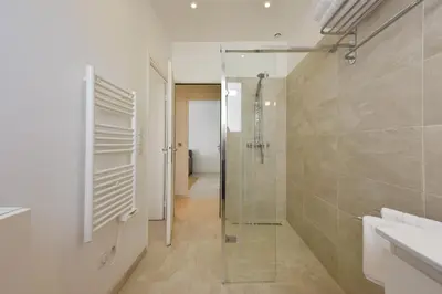 a bathroom with a shower and a glass shower stall at 1-bedroom apartment walk to beach garage in Cannes