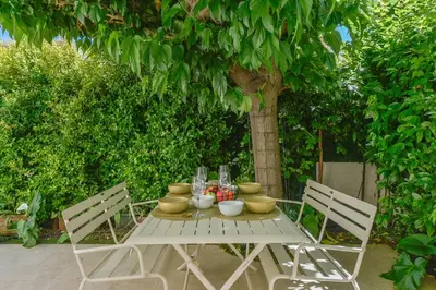 a white table with bowls and vases on it at 1-bedroom apartment walk to beach garage in Cannes