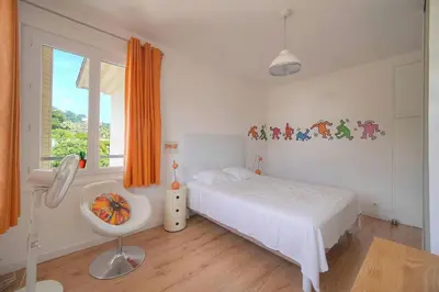 a bedroom with a bed and a sink and a window at FRGK Isola Bella ' Appartement Confortable' in Cannes