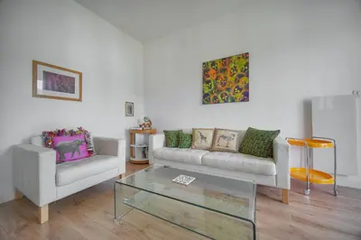 a living room with a couch and a glass table at FRGK Isola Bella ' Appartement Confortable' in Cannes
