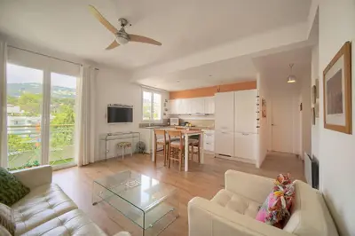 a living room with a couch and a table at FRGK Isola Bella ' Appartement Confortable' in Cannes
