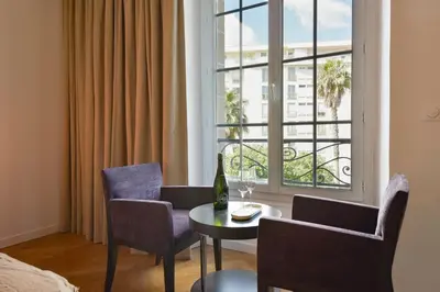 a room with a table and chairs and a window at Rare luxury 3-Br near the Croisette in Cannes