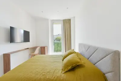 a bedroom with a bed with a yellow pillow on it at Rare luxury 3-Br near the Croisette in Cannes