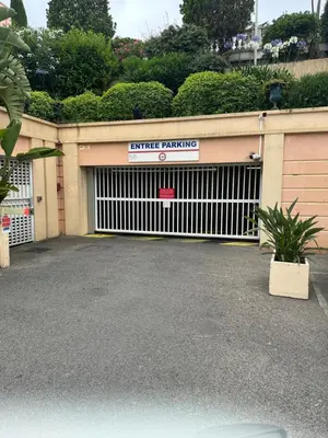 a garage door with a garage parking sign on it at Villa Francia Résidence piscine tennis à 500m des plages de Cannes in Cannes