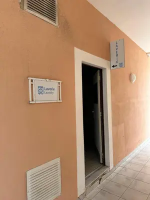 a sign on the side of a building with a door at Villa Francia Résidence piscine tennis à 500m des plages de Cannes in Cannes
