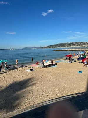 a group of people on a beach with the ocean at Villa Francia Résidence piscine tennis à 500m des plages de Cannes in Cannes