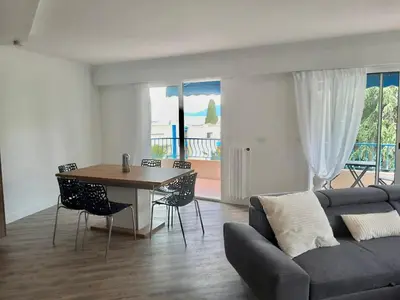 a living room with a couch and a table at Appartement vue mer, Long Beach in Cannes