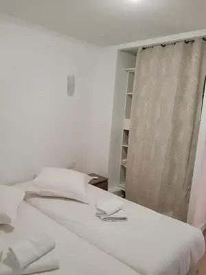a white bed in a room with a window at Appartement vue mer, Long Beach in Cannes