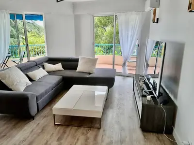 a living room with a couch and a coffee table at Appartement vue mer, Long Beach in Cannes