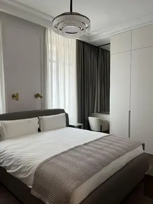 a bedroom with a large bed and a chandelier at Apartments in the old town in Cannes