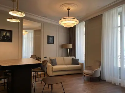 a living room with a couch and a table and chairs at Apartments in the old town in Cannes