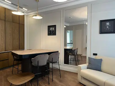 a kitchen and living room with a bar and a couch at Apartments in the old town in Cannes