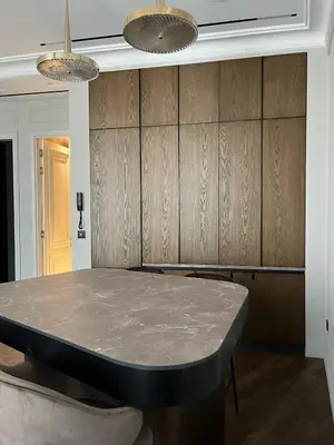 a dining room with a marble table and two lights at Apartments in the old town in Cannes