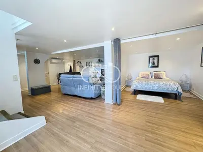 a living room with a blue couch and a staircase at Grand 2p Proche Palais - Boulevard Delaup Cannes in Cannes