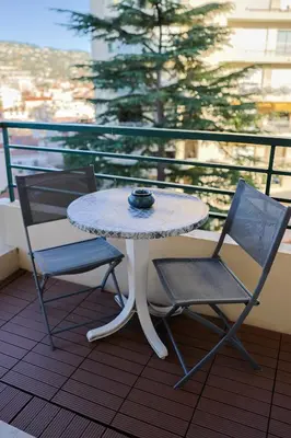 a white table and two chairs on a balcony at Appartement à 10min à pied Palais Festivals in Cannes