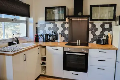 a kitchen with a sink and a stove top oven at Appartement à 10min à pied Palais Festivals in Cannes