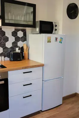 a kitchen with a white refrigerator and a microwave at Appartement à 10min à pied Palais Festivals in Cannes