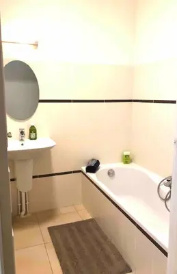 a bathroom with a tub and a sink and a mirror at Appartement 3 pièce à Cannes in Cannes