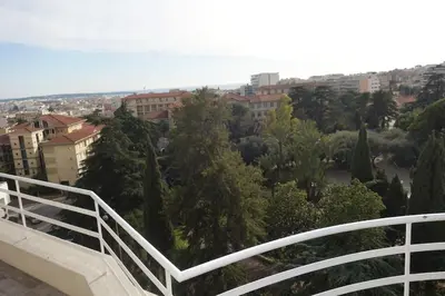 a balcony with a view of trees and buildings at Studio Toit terrasse - Vue mer Cannes in Le Cannet