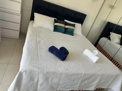 a white bed with blue towels and pillows on it at Super Apartment, Parking, Terrace, Lift, WIFI, Palm Beach, Cannes in Cannes