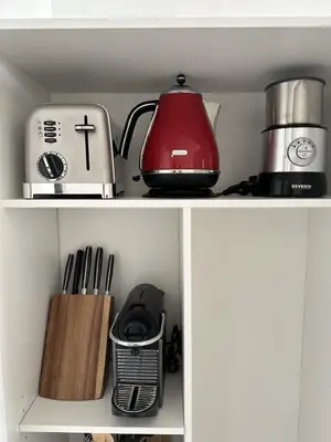 a kitchen shelf with a tea kettle and utensils at Super Apartment, Parking, Terrace, Lift, WIFI, Palm Beach, Cannes in Cannes