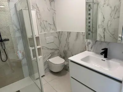 a bathroom with a sink and a toilet and a shower at Super Apartment, Parking, Terrace, Lift, WIFI, Palm Beach, Cannes in Cannes