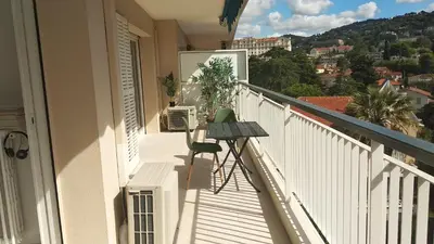 a balcony with a table and a view of a city at Beau 2 pièces centre de Cannes idéal congres et vacances in Cannes