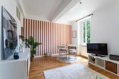 a living room with a red and white striped wall at maison de ville La Fontaine BAu4 in Le Cannet