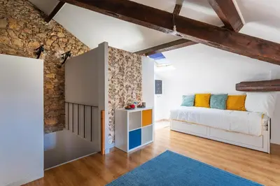 a bedroom with a bed and a wall at maison de ville La Fontaine BAu4 in Le Cannet
