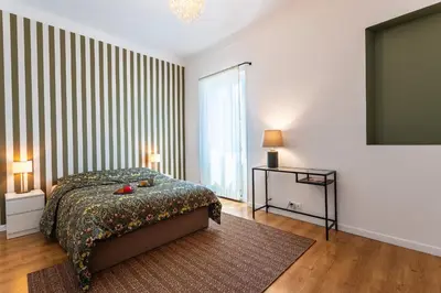 a bedroom with a bed and a large window at maison de ville La Fontaine BAu4 in Le Cannet