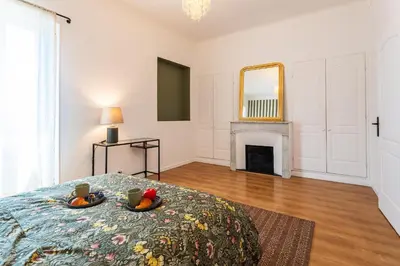 a bedroom with a bed and a fireplace at maison de ville La Fontaine BAu4 in Le Cannet