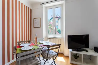 a small living room with a table and a television at maison de ville La Fontaine BAu4 in Le Cannet
