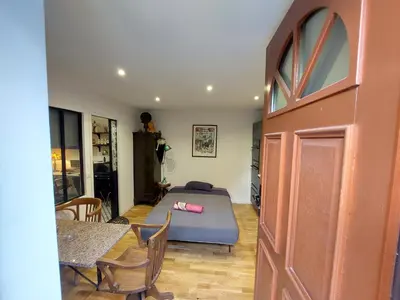 a bedroom with a bed and a table and chairs at Cité Saint Paul Terrasse Parking Clim Wifi Sauna in Cannes