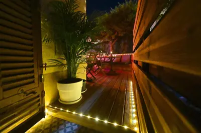 a potted plant sitting on a deck with lights at Cité Saint Paul Terrasse Parking Clim Wifi Sauna in Cannes