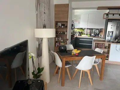a kitchen and dining room with a table and chairs at Chambre cosy dans T3 in Cannes