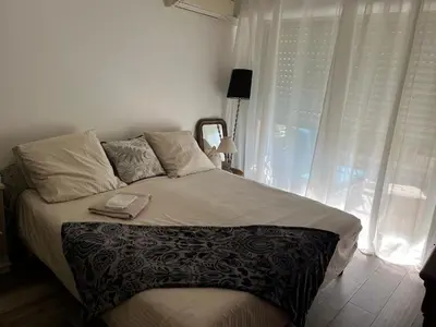 a bedroom with a large bed with a window at Chambre cosy dans T3 in Cannes